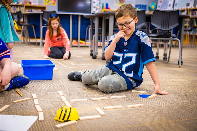 Students use Bee-Bots in the Learning Commons